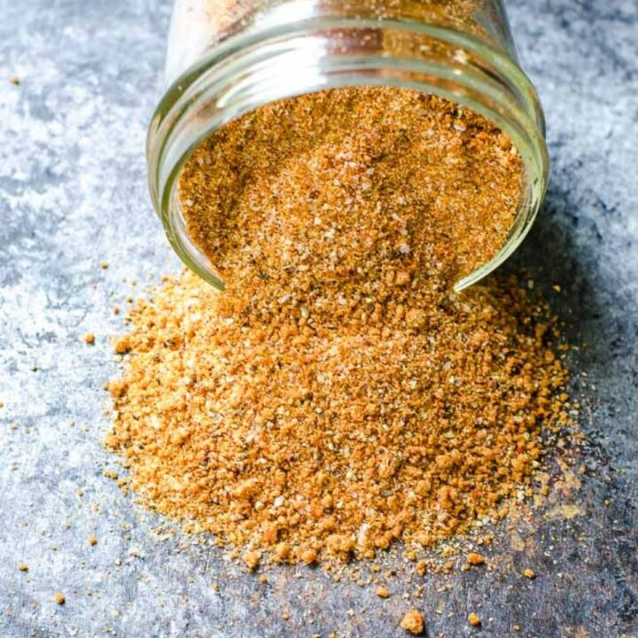 A jar spilling dry rub for ribs