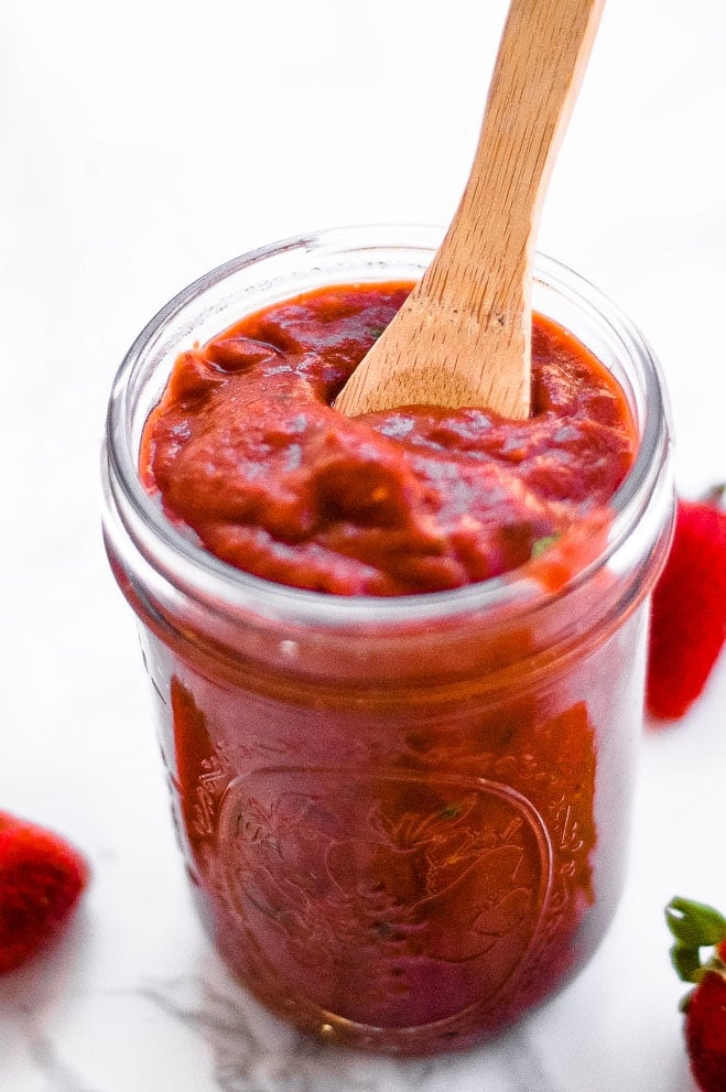 Closeup of a jar of chipotle bbq sauce with wooden spoon