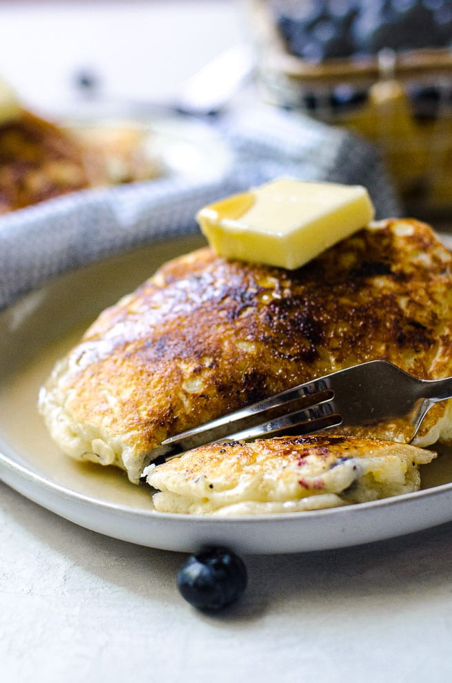 A fork cutting into a pancake.