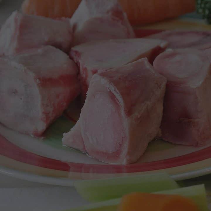 Black overlay on a plate of bones for roasting.