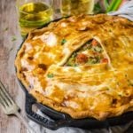 A fork next to a skillet pot pie made out of leftover turkey.