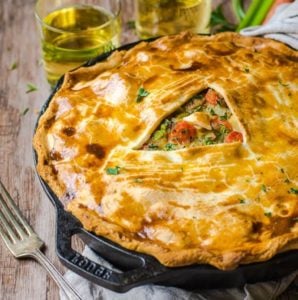 A fork next to a skillet pot pie made out of leftover turkey.