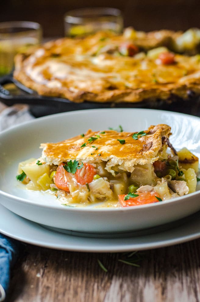 A single piece of pot pie on a white plate.