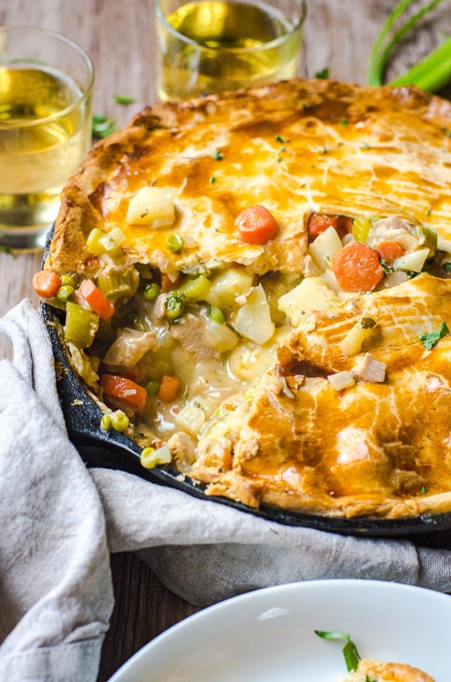 A view of the inside of a cooked turkey pot pie showcasing the gravy.