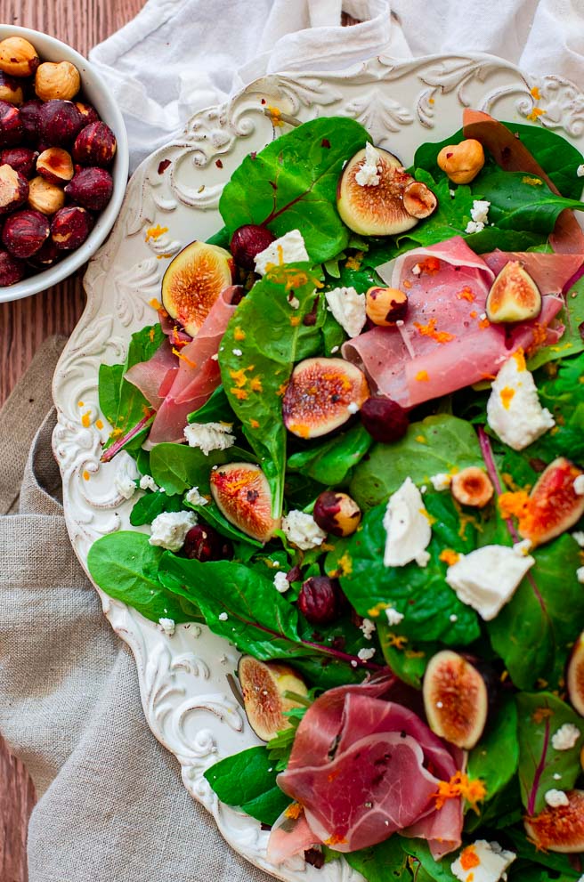 Overhead view of a white platter of salad.