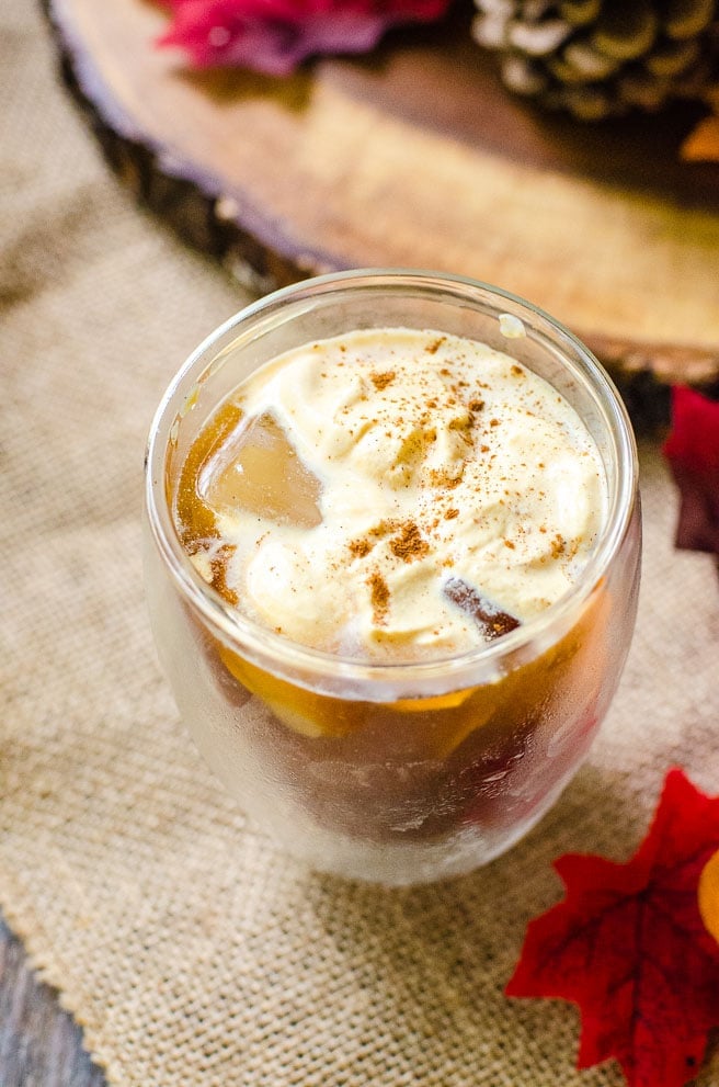 An overhead view of a cup of pumpkin cream cold brew topped with pumpkin spice.