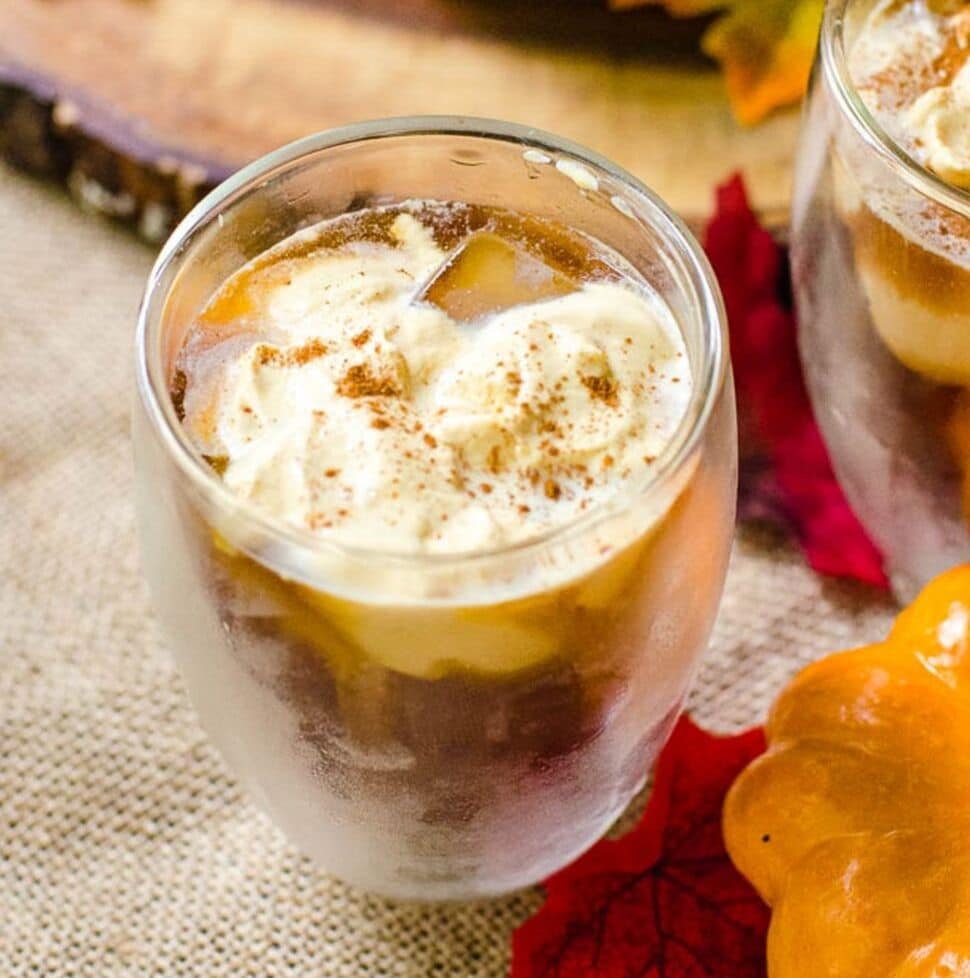 A glass of pumpkin cream cold brew on a piece of burlap.