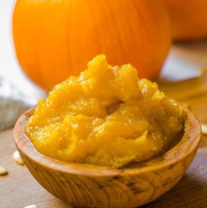 Close up of an overflowing bowl of homemade pumpkin puree.