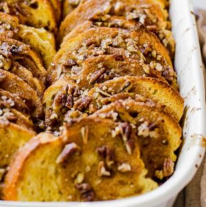 Cooked overnight pumpkin french toast in a white baking tray.