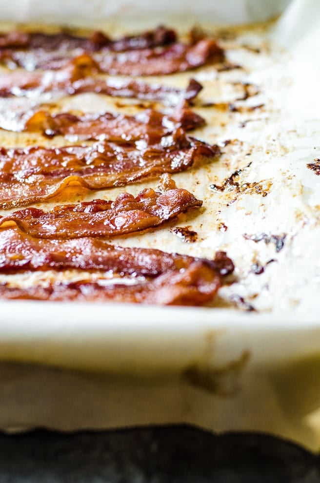 Parchment paper with cooked bacon and grease on it.
