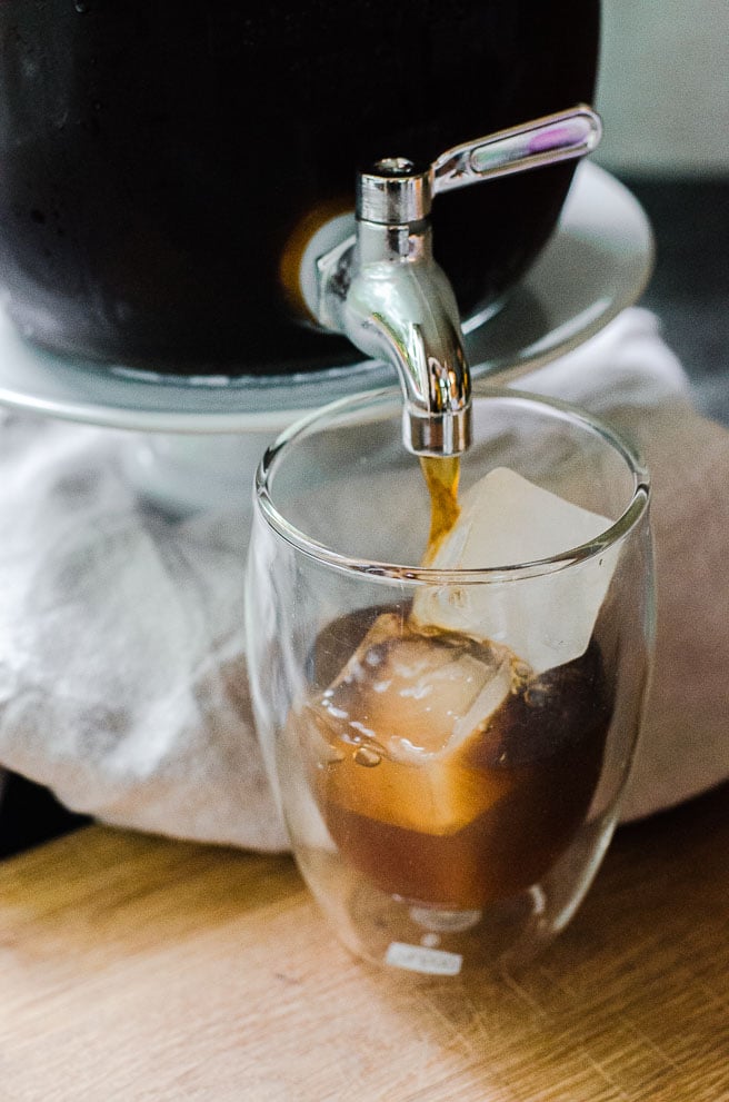 Coffee pouring onto square ice cubes.