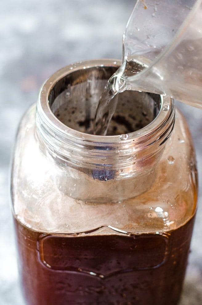 Water being poured into a cold brew coffee maker