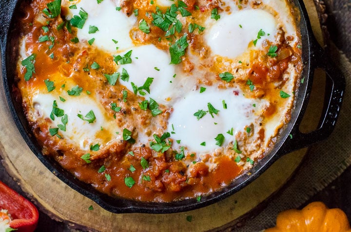 Overhead view of poached eggs in shakshuka.