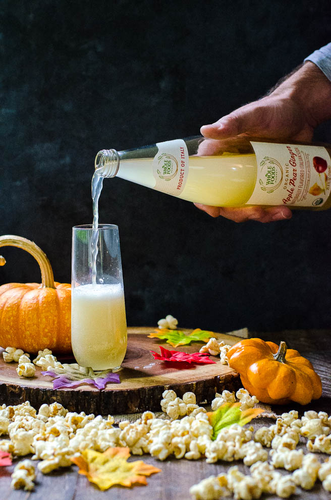 Whole Foods Apple Pear Ginger soda being poured into a glass.