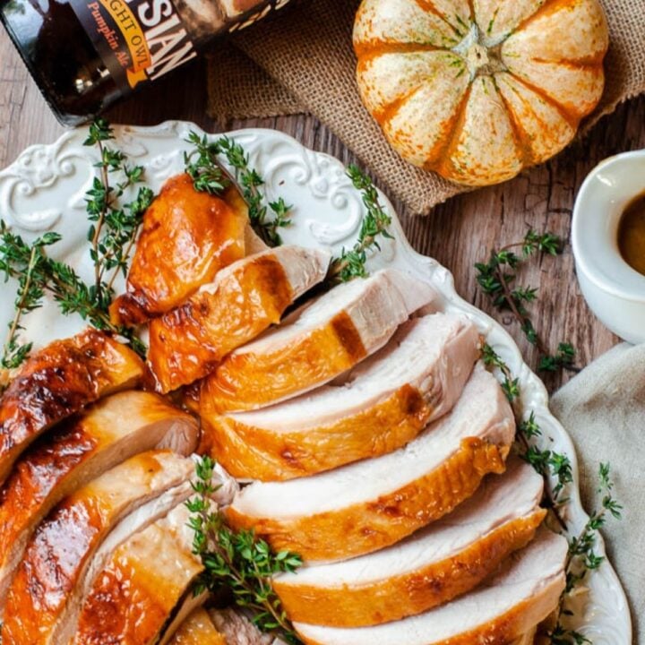 A whole cut turkey into thick slices topped with spice
