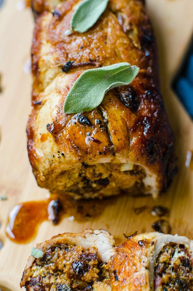 Close up of white wine pan sauce dripping off of pork roulade.