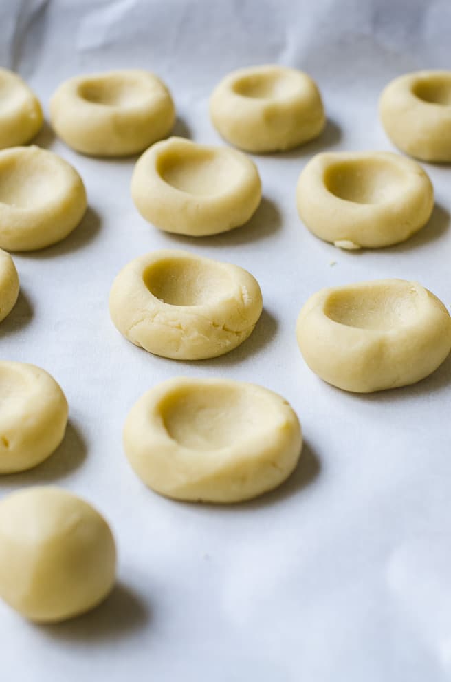 Shortbread cookie dough with thumbprint impressions.