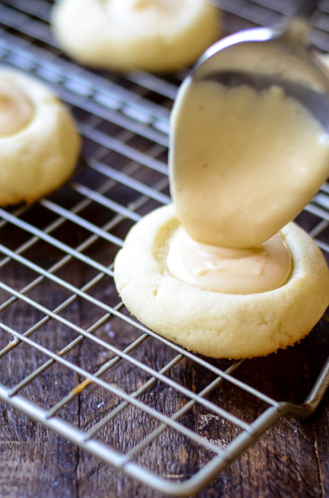 A spoon drizzling brown butter icing.