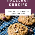 Chewy hazelnut oatmeal cookies on a cooling rack. Recipe title is above it on a purple background.