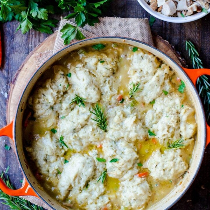 A pot holding actively cooking dumplings completed with rosemary spice