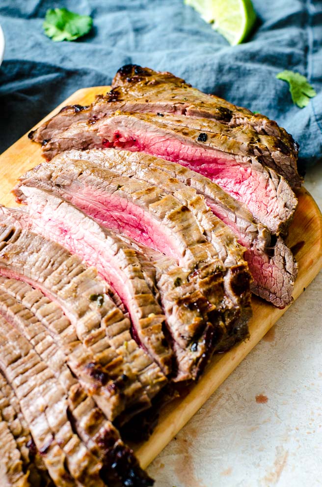 Close up of flank steak cooked to medium rare.