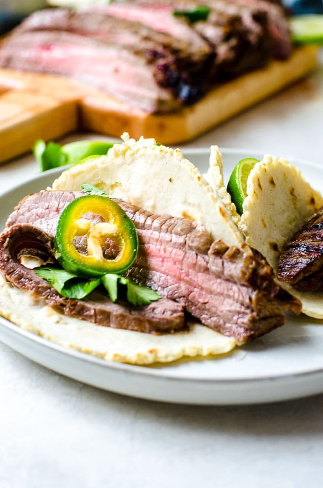 Inside of a carne asada taco with a jalapeno slice.