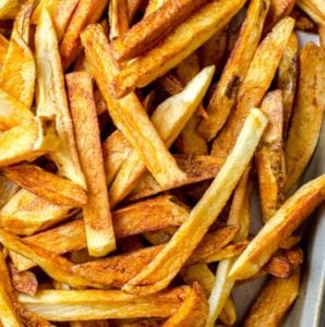 A large pile of golden brown homemade french fries.