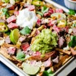 Perfect for game day, these crispy french fries are topped with melted cheese, sour cream, guacamole, and smoky carne asada meat.