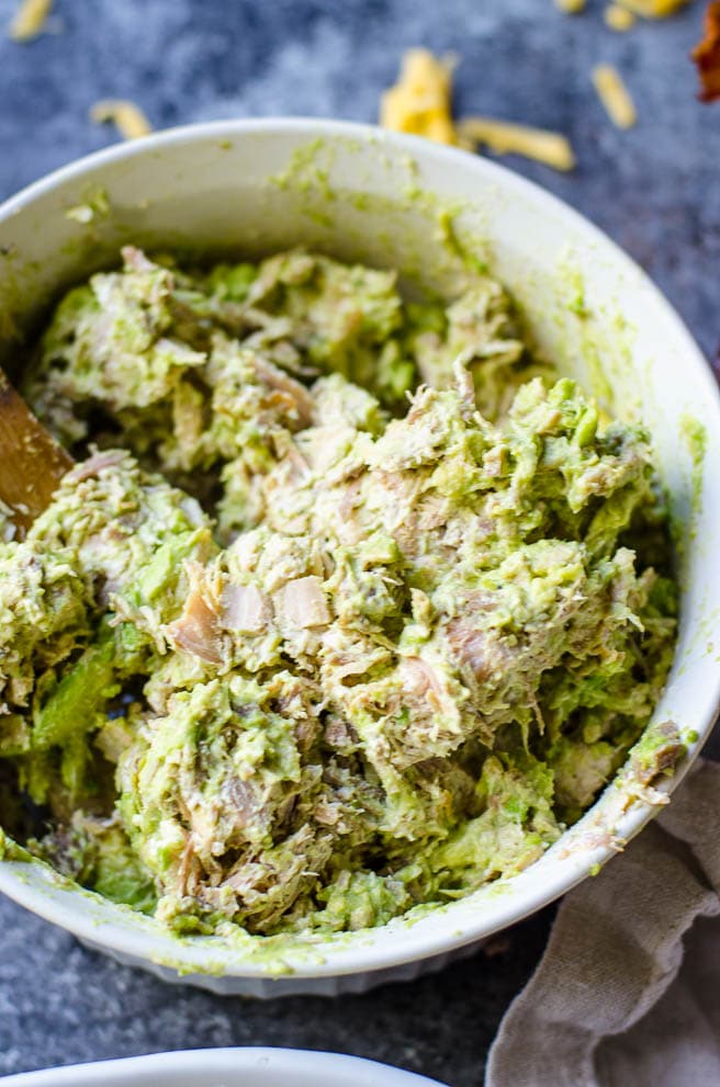 A bowl of cream cheese, avocado, and turkey mixed together.