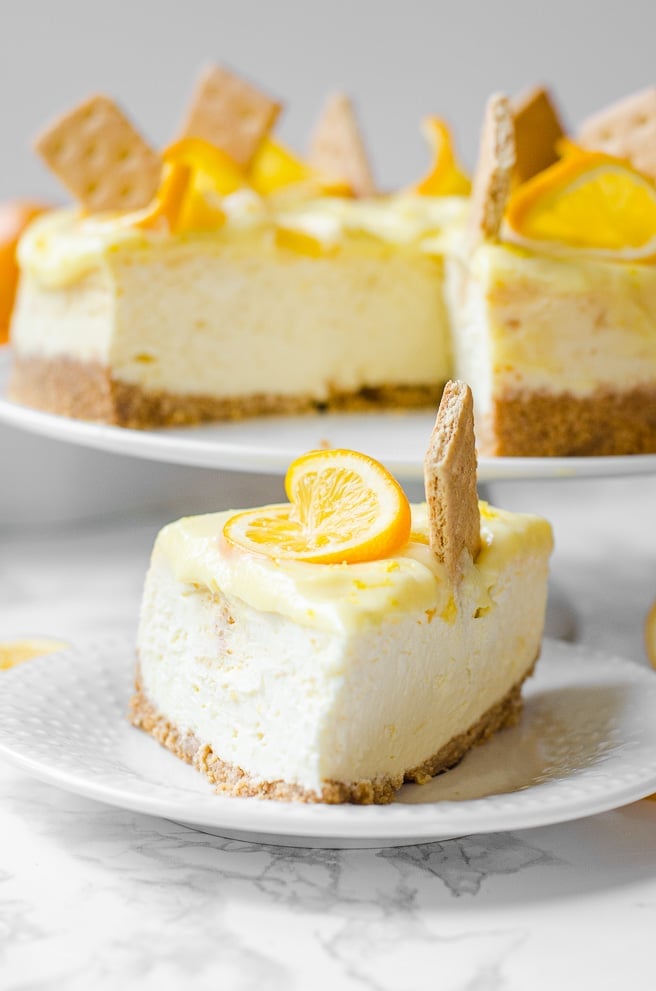 Straight on view of the point of a slice of meyer lemon cheesecake.