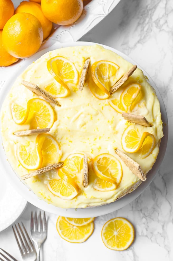 Overhead view of a cheesecake showing a way to garnish it with lemon wheels.