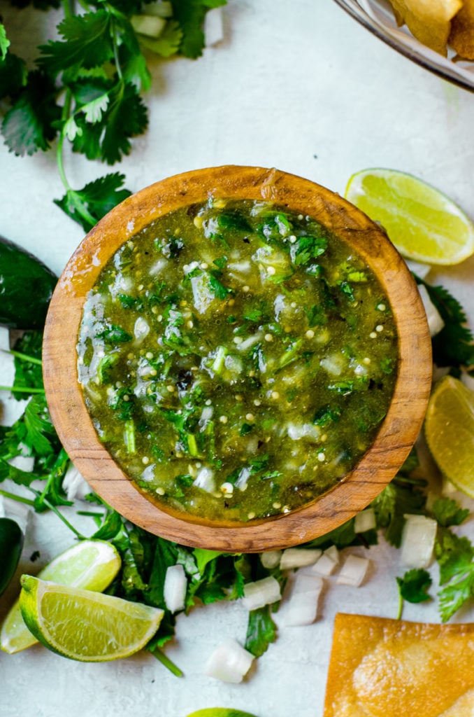 Overhead view of salsa verde in a wooden bowl.