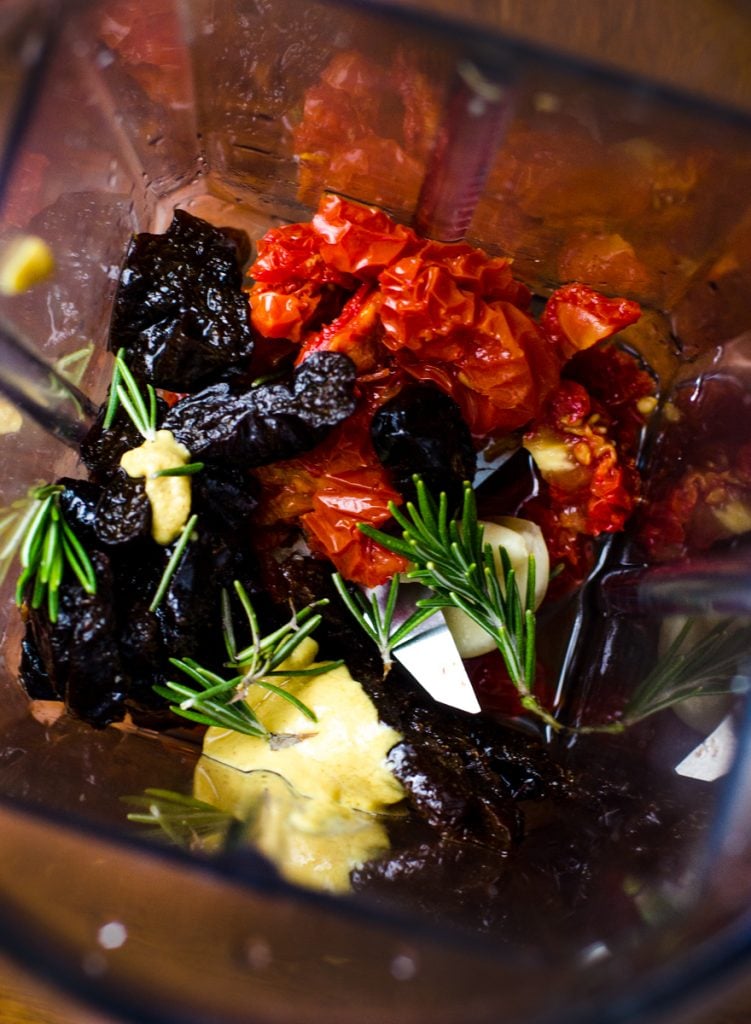 The inside of a blender getting ready to make salad dressing.