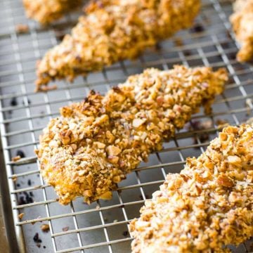 Almond crusted chicken tenders on a baking rack.