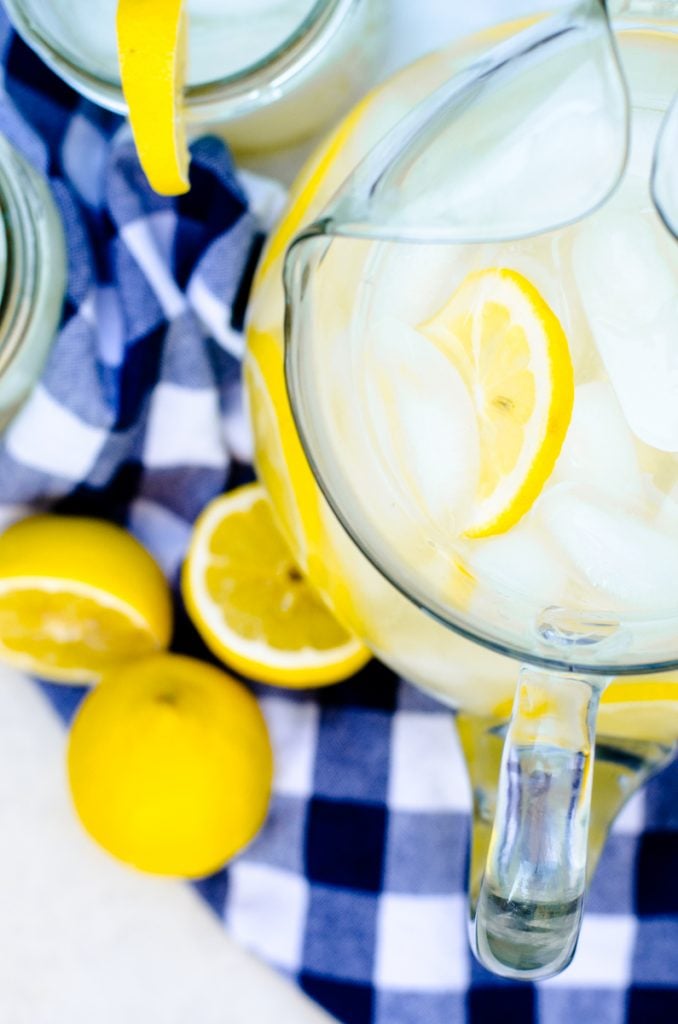 A pitcher of lemonade concentrate with fresh lemons in it.