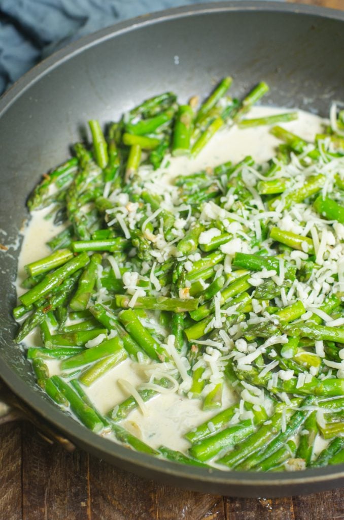 Asparagus cooking in a cream sauce.