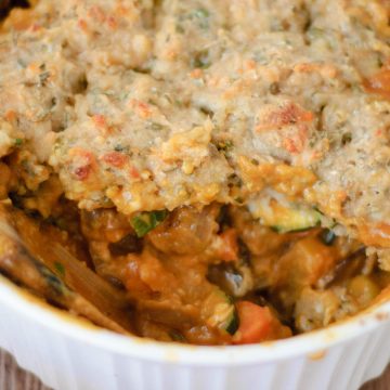 a spoon dipping into savory pumpkin casserole.