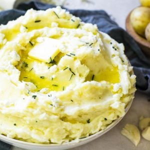 A butter pat melting on top of goat cheese mashed potatoes.