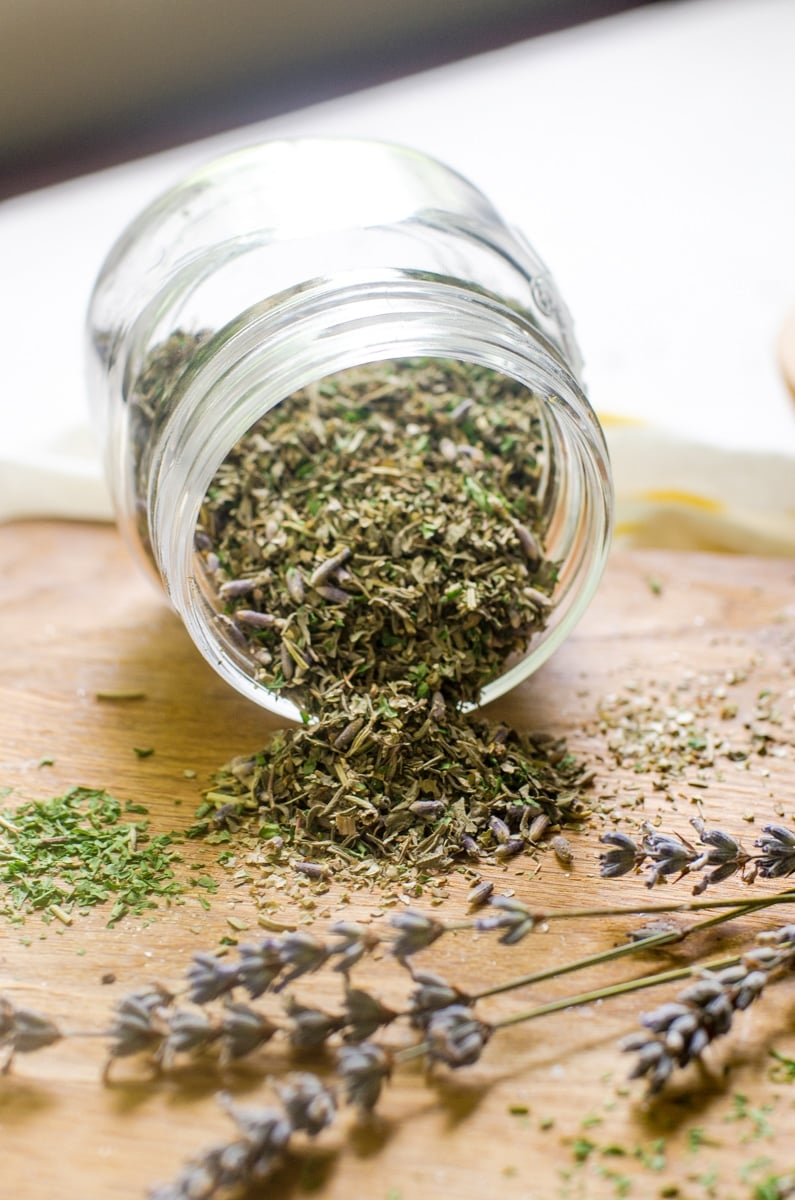 Herbs de Provence pouring out of a spice jar.