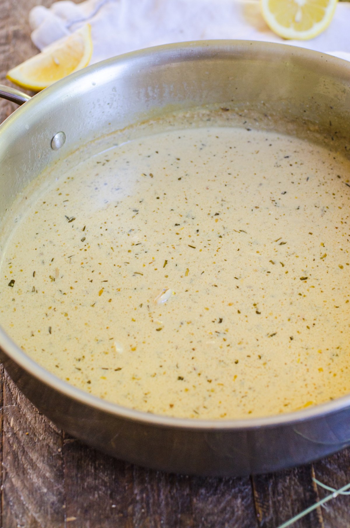 A herbs de provence lemon cream sauce in a saute pan.
