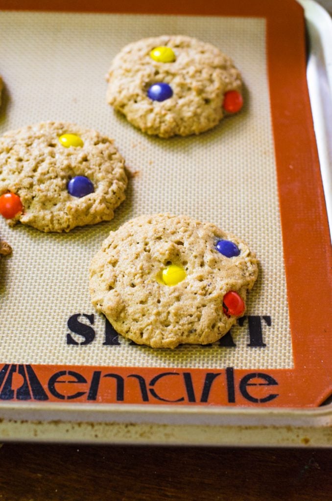 A baking sheet of hocus pocus cookies showing how they puff up during baking.