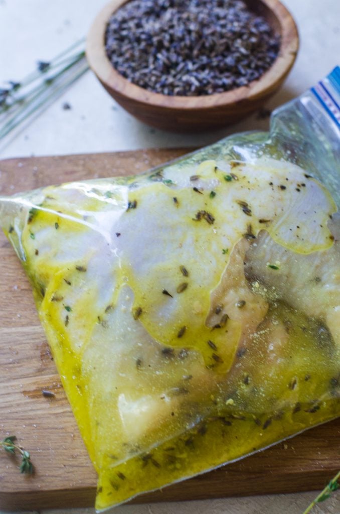 Chicken leg quarters in a ziploc bag of marinade.