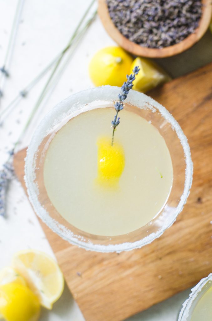 Overhead view of a cocktail on a wooden board.