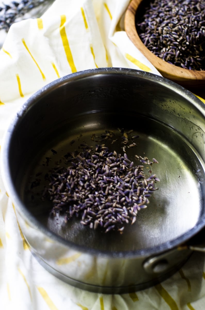 Lavender floating in a saucepan of liquid.