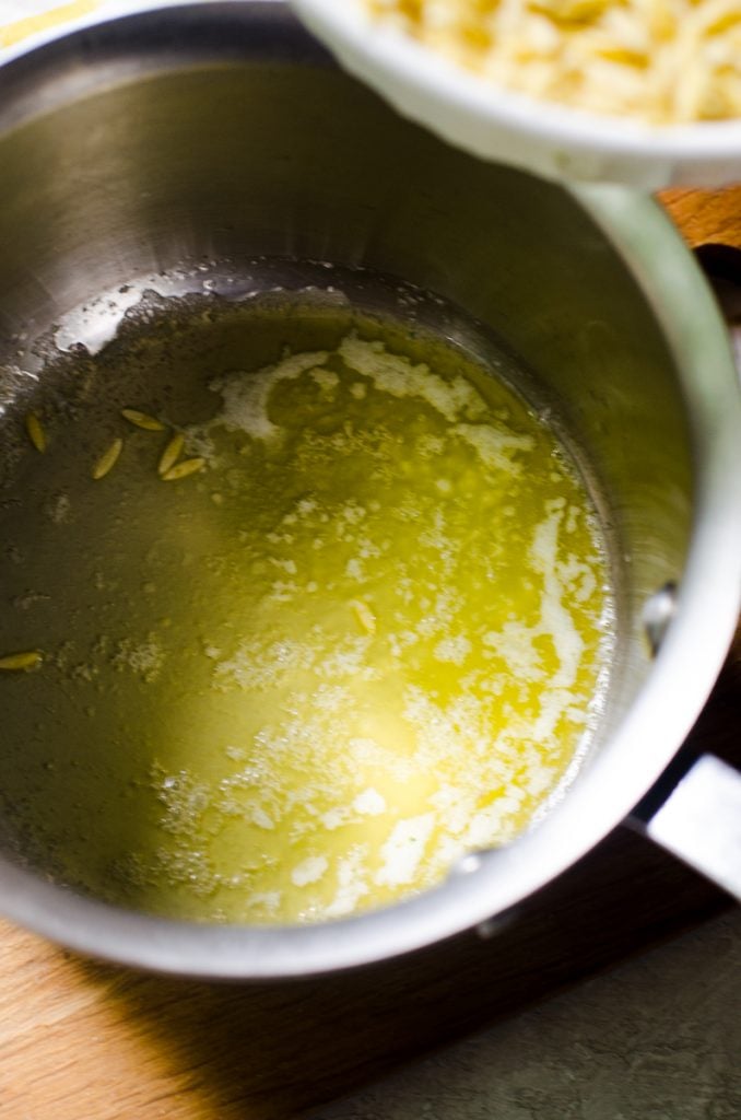 Melted butter in the bottom of a pan.