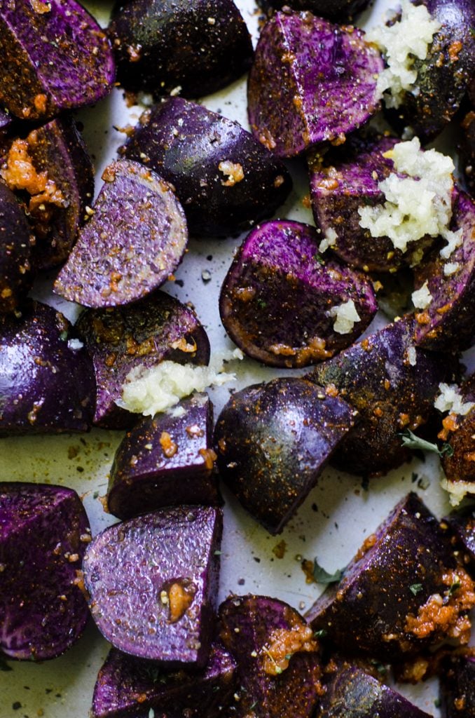 Raw purple potatoes tossed with garlic.