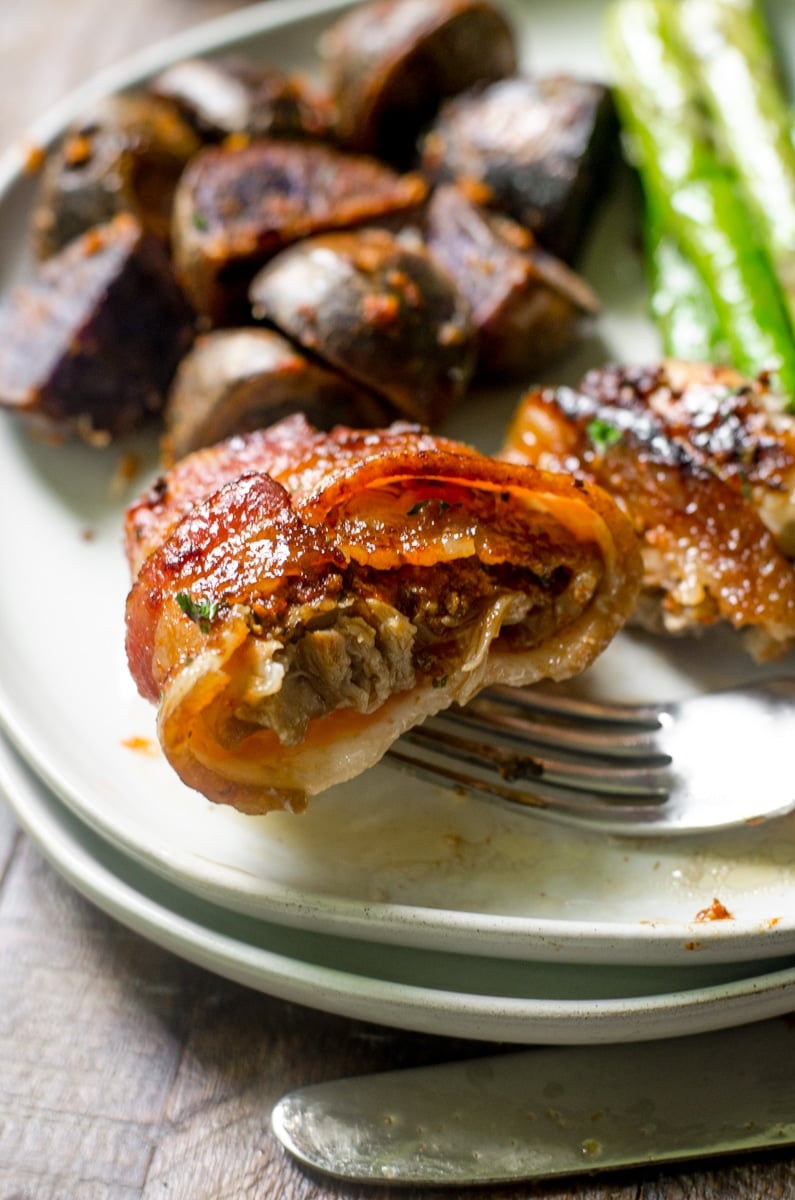 Inside of a piece of moist chicken thigh on a fork.