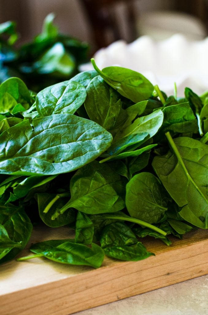 A cutting board of spinach