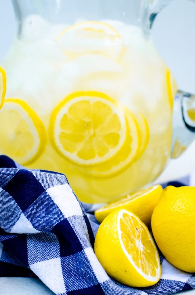 Fresh lemons in a pitcher of concentrate.