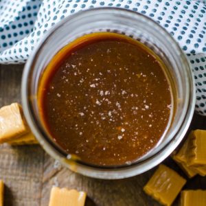 Overhead view into a jar of salted caramel sauce.